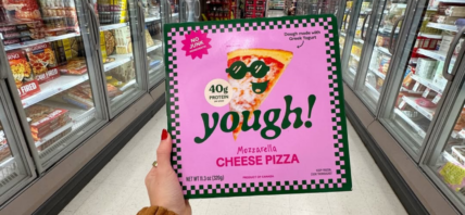 Someone holding up a box of Yough Pizza.