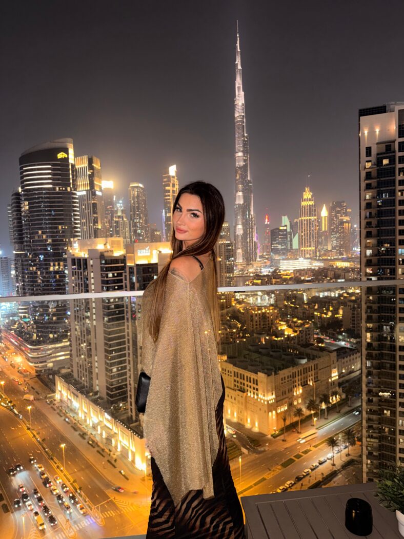 Woman standing in front of city skyline.