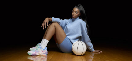 Angel Reese posing with new edition of her signature shoe.