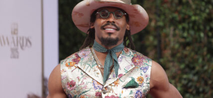 Cam Newton posing on the red carpet.