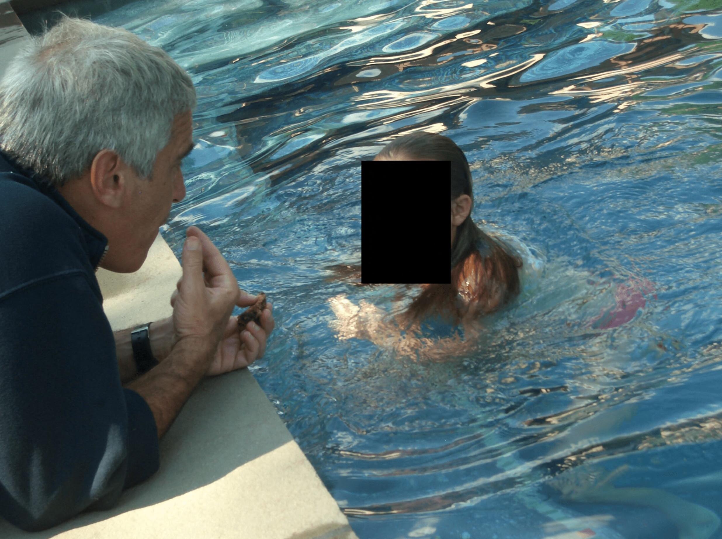 Jeffrey Epstein osing with what appears to be a child in these undated photo released by the U.S. Department of Justice