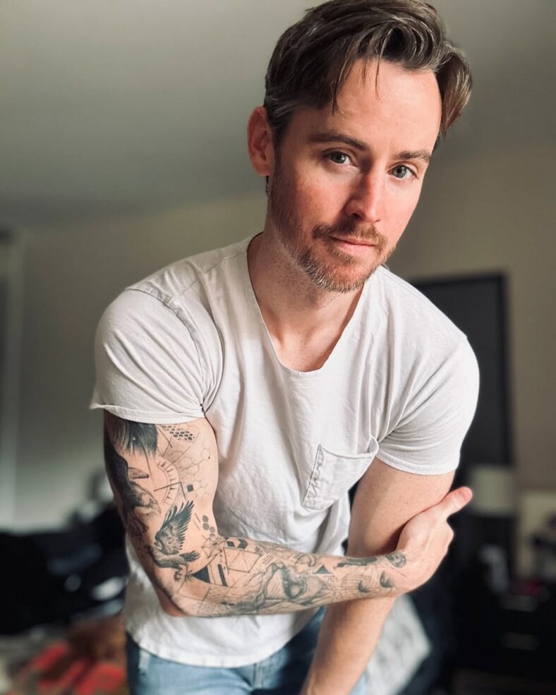 Daniel Benson posing in white t shirt