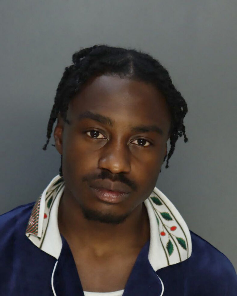 Lil Tjay poses for mugshot after being arrested while boarding a private jet in Miami - on his 23rd birthday.