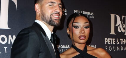 Megan Thee Stallion and Klay Thompson posing on the red carpet.
