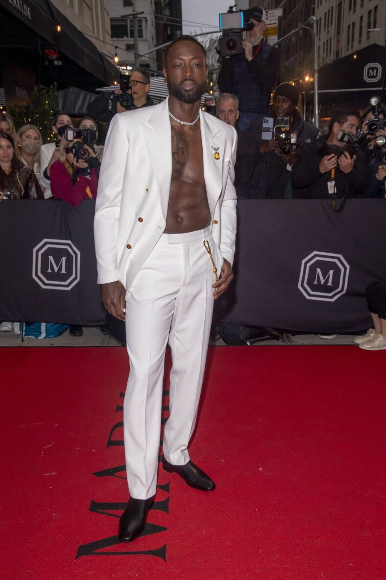 Dwyane Wade wearing a white suit. 