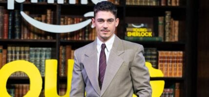 Hero Fiennes Tiffin in a beige suit