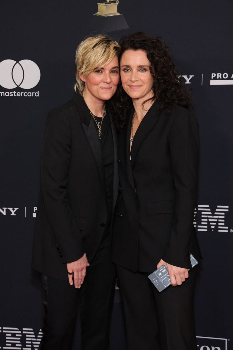 Brandi Carlile posing with someone on the red carpet. 