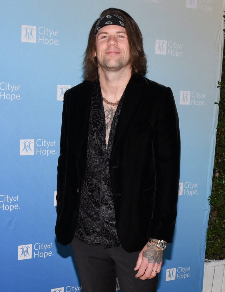 Caleb Shomo posing on the red carpet. 