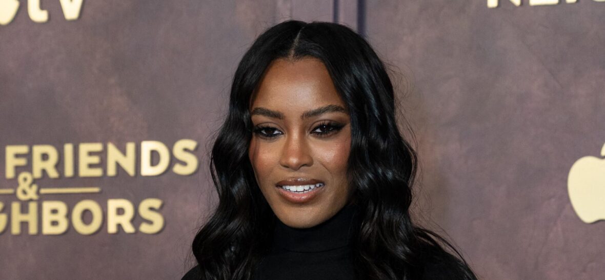 Ciara Miller posing on the red carpet.