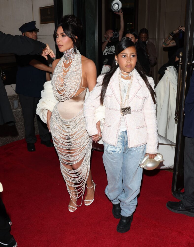 Kim Kardashian Stuns in Pearls with Daughter North West, leaving the Ritz Hotel on their way to the Met Gala.