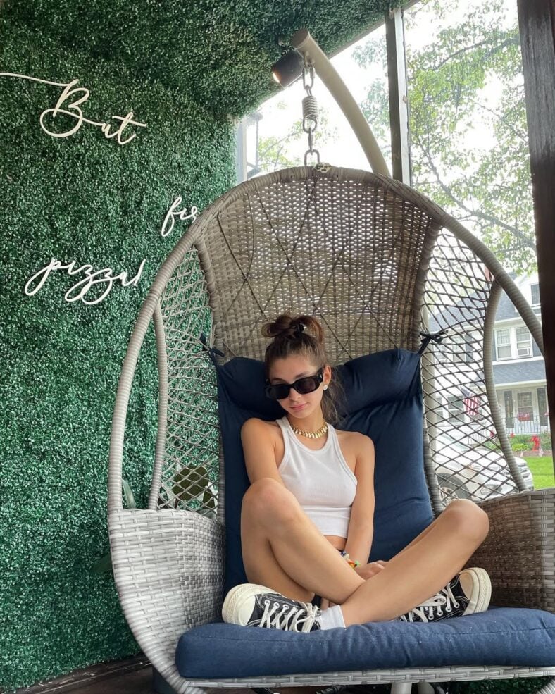 Mackenzie Shirilla sitting in an egg chair