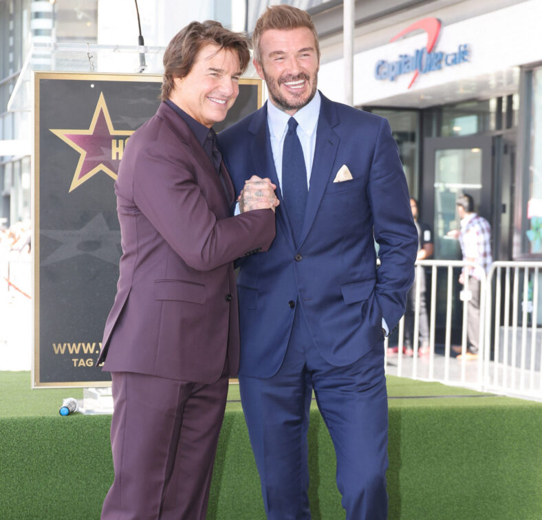 Tom Cruise and David Beckham hold hands at the football star Walk of Fame ceremony