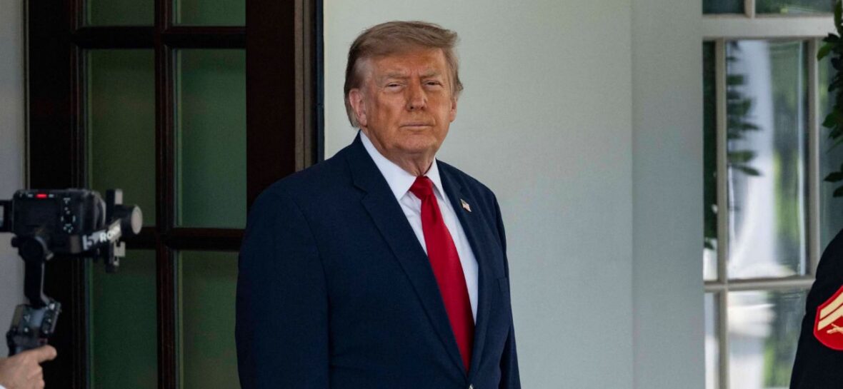 Donald Trump waits outside the White House
