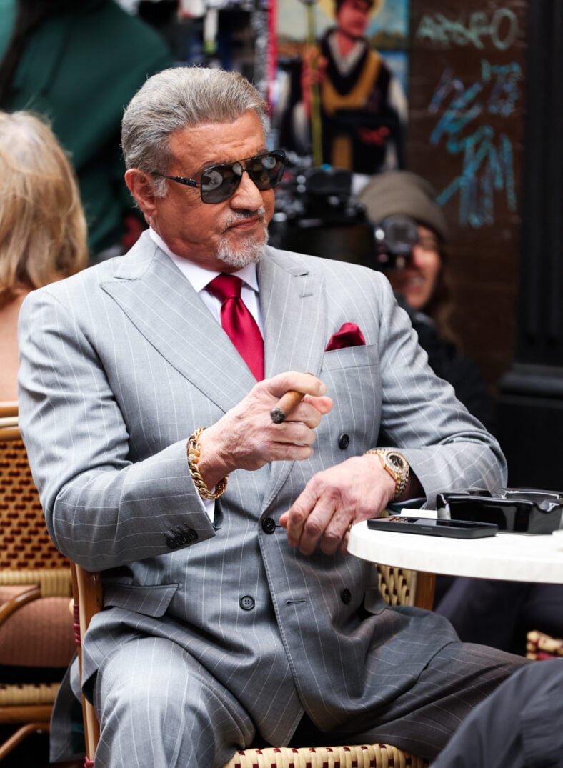 Sylvester Stallone is seen smoking a cigar as he films scenes for his show Tulsa King this morning in New York City