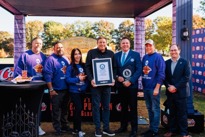 Raising Cane's owner and founder Todd Graves completes carving for Guiness World Record heaviest Jack o'lantern at Salem Common on October 27, 2026